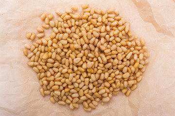 peeled pine nuts on a rustic background