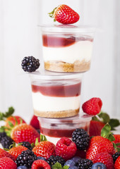 Plastic container with berries cream dessert
