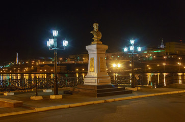 Embankment of the Izhevsk pond and a monument to A.F. Deryabin, the founder of the arms factory, installed in 1907. Russia, Izhevsk at night