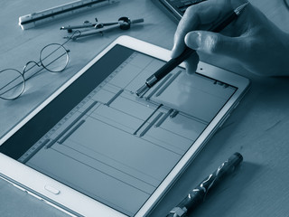 engineer working on tablet computer on chart of project time table progress chart of project monochrome image