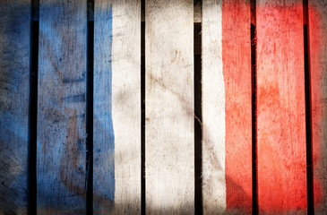 Grunge filtered,France national flag on wood background.