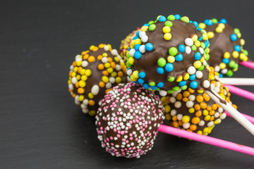 cake pops with a variety of brightly colored sprinkles