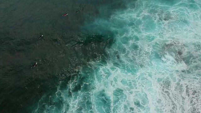 Aerial view from a surf spot with waves and a group of surfers in Ericeira, Portugal