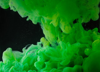 Fototapeta na wymiar close-up view of bright green abstract paint on black background