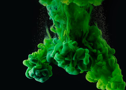 Close-up View Of Green Abstract Ink Explosion On Black Background