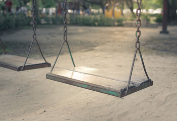 Wooden old swings in playground