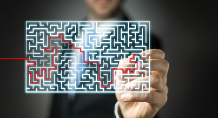 Businessman searching solution of a complicated maze