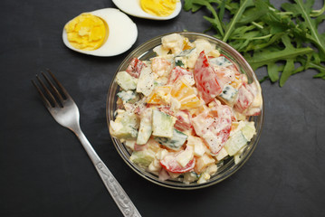 Vegetable Salad Bell Pepper, Tomato, Cucumber, Eggs and Mayonnaise. Health Vegan salad. Glass Bowl Black Board.
