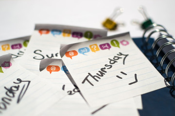 the name of the day of the week written on a sticky sheet in a blue notebook with springs