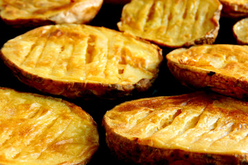 Baked potato halves. Ruddy baked potatoes in the peel.