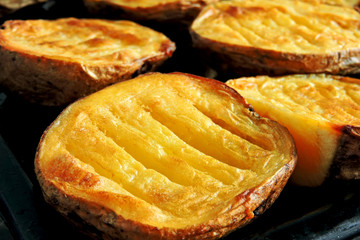 Baked potato halves. Ruddy baked potatoes in the peel.