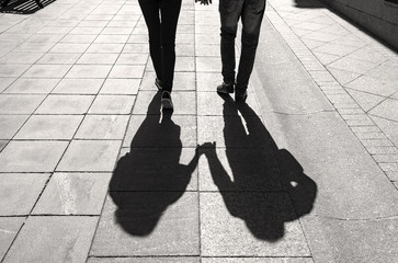 Silhouettes and Shadows of young Couple in a street Lovers walking in the City