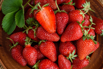 Tasty strawberry on a wooden table. It can be used as a background