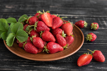 Tasty strawberry on a wooden table. It can be used as a background