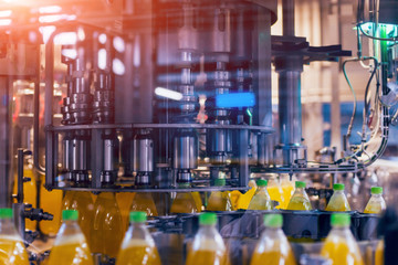 Automatic filling machine pours water into plastic PET bottles. Brewing production.