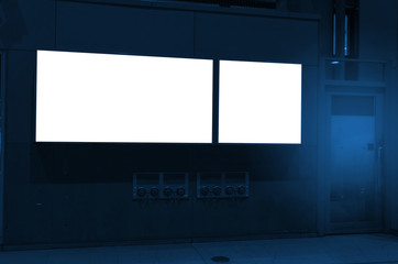 two frame blank advertising billboard on wall with copy space for your text message or media and content in subway train station or airport, banner, marketing and advertising concept, blue color tone
