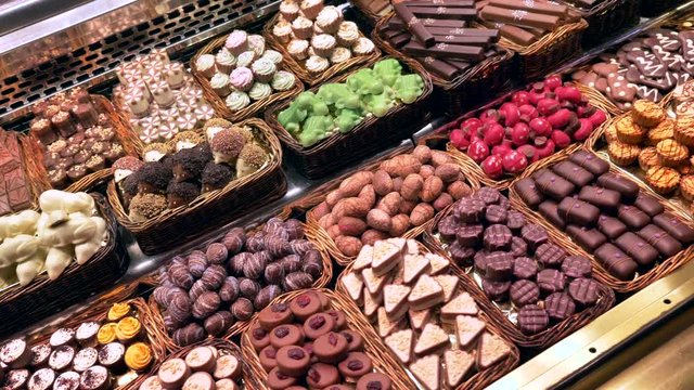 Dolly shot over Chocolate pralines display at La Boqueria market, Barcelona.
