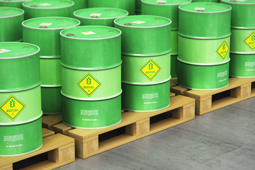 Group of green biofuel drums on shipping pallets in the storage warehouse