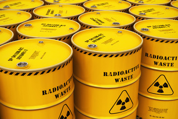 Group of stacked yellow drums with radioactive waste