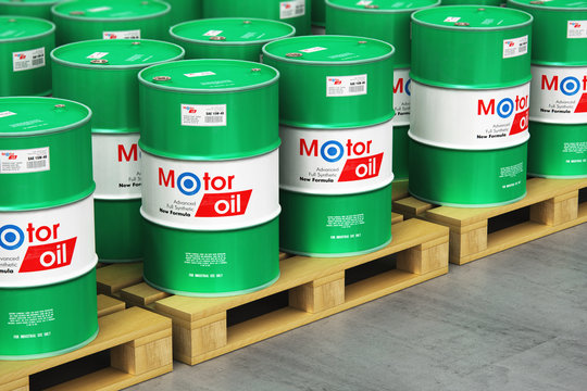 Group of barrels with motor oil lubricant on shipping pallets in warehouse