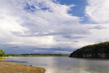 Obraz premium Beautiful river landscape. Calm river with colorful sky reflection on it. River flow on sunset