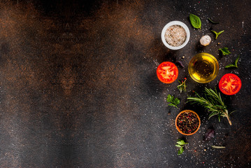 Fototapeta na wymiar Cooking background, herbs, salt, spices, olive oil, dark rusty background copy space top view