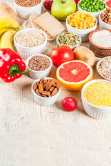 Diet food background concept, healthy carbohydrates (carbs) products - fruits, vegetables, cereals, nuts, beans, light concrete background copy space