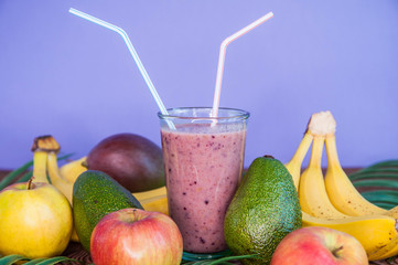 Healthy fresh appetizing colorful smoothie cocktailwith a straw and with tropical fruits