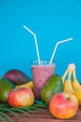 Healthy fresh appetizing colorful smoothie cocktailwith a straw and with tropical fruits