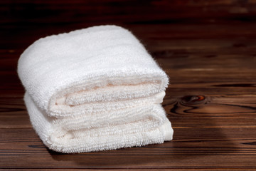 Obraz na płótnie Canvas white cotton towels folded on wooden background, close up