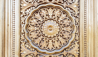 amazingly beautiful traditional Uzbek floral ornament carved on the wooden door of the mosque