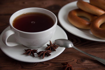 White cup of black tea or coffee on vintage wooden table