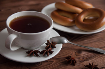 White cup of black tea or coffee on vintage wooden table