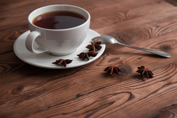 White cup of black tea or coffee on vintage wooden table