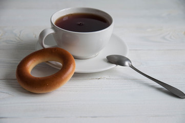 White cup of black tea or coffee on vintage wooden table