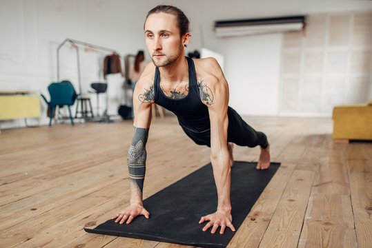 Male yoga doing push up exercise