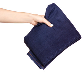 Blue jeans in hand on a white background isolation