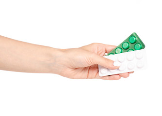 Pills in hand on a white background isolation