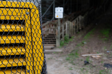 Yellow Generator Behind Black Fence and Sign 