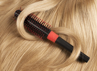 Long blond human hair with a comb