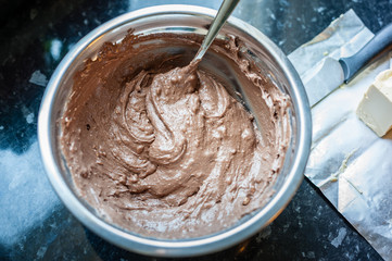 Fototapeta premium Mixing dough for muffin or cupcakes. Process of preparation of cupcakes. Close up, soft focus. Homemade Cupcakes.