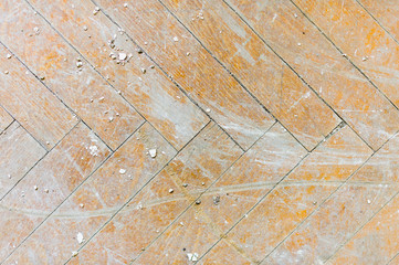 A close-up of an old faded parquet covered with dust and dirt. Result of repair. Cleaning and cleaning required