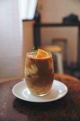 Iced Coffee latte with orange mix in close up
