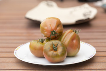 tomatoes on a plate on the table