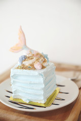 Fancy mermaid cake on wood background