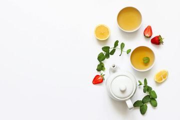 Herbal tea from mint and strawberry with lemon other herbs on a white background. T