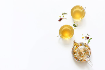 Herbal tea of mint, chamomile, rose hip and other herbs on white background.