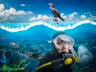 Wall murals Diving Diver in diving gear gasps under water