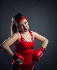 Portrait of female boxer in red boxing gloves