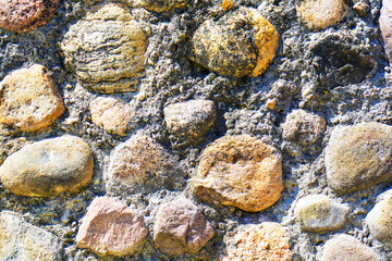Background of old stone wall texture photo. Colorful old stone wall